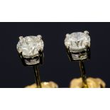 A pair of diamond solitaire 18ct white gold earrings, the two round brilliant cut diamonds approx 0.