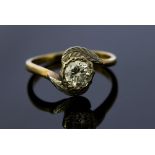 A diamond solitaire 18ct gold ring, with cross over shoulders,