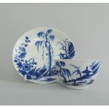 A Worcester blue and white tea bowl and saucer decorated with 'The Landslip' pattern, circa 1755-60,