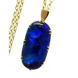 A large black opal pendant, a solid black opal showing blue and green play of colour,