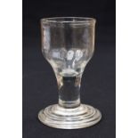 An 18th century toasting glass, the ogee bowl with moulded fluting to the lower third,