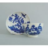 A Worcester blue and white tea bowl and saucer, decorated with 'Birds In Branches' pattern,