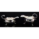 A George II silver cream jug, shaped rim with three hoof feet, C-scroll handle, London,