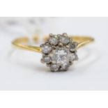 A diamond cluster 18ct gold ring, the centre round brilliant cut diamond approx 0.