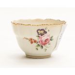 A Derby porcelain tea bowl, ogee form with gilt dentil border and floral sprays, circa 1775,