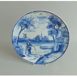 A Dutch Delft 'May' (Mei ) calendar plate, an early summer scene decorated in under-glaze blue,