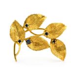 An 18ct yellow gold leaf spray brooch, set with small blue zircons, hallmarked 1969,