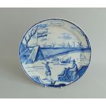 A Dutch Delft 'January ' calendar plate, a winter scene decorated in under-glaze blue,