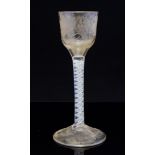 An 18th century opaque twist wine glass, the ogee bowl with engraved fruiting vines,