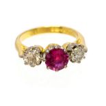 A ruby and diamond three stone ring, the central round mixed cut ruby weighing approx 1.