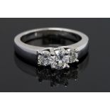 A diamond three stone 14ct white gold ring, three round brilliant cut diamonds,