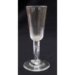 An 18th century ale flute, the round funnel bowl on a triple strand air twist stem and conical foot,