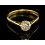 A diamond solitaire 18ct gold ring, the round brilliant cut diamond weighing approx 0.