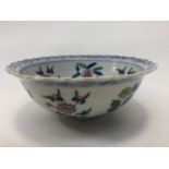 A Chinese porcelain (Doucai) style bowl with barbed rim painted with stylised flowers,