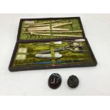 A ladies manicure set with mother of pearl handles, bone needles, glove stretchers, hooks, etc,