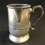 A pewter quart tankard with pouring spout,