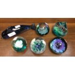 Five Caithness paperweights and a blue glass Dolphin (6)
