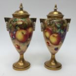 A pair of Royal Worcester fruit painted pedestal vases and covers, both signed Freeman,