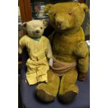 A pair of early 20th Century, well loved mohair Teddy Bears, one in yellow outfit, one eye missing,