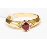 An 18ct gold, ruby and diamond ring, rub over set oval ruby approx 4mm x 3.