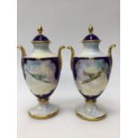 Two Caverswall lidded Campana urns, hand painted by Roger Shufflebothom,