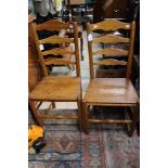 A pair of early 19th Century elm ladder back chairs (2)