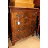 A reproduction serpentine chest of drawers of small proportions