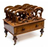 A Victorian rosewood scroll carved Canterbury, having three tiers,