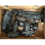 A box containing a large quantity of African ebony carved figures, comprising a pair of busts,