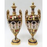A pair of Royal CrowN Derby Imari 1128 pattern twin handled urn vases,