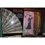 A collection of costume/textiles books and fans,