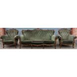 A Victorian beech three piece suite, comprising a settee and a matching pair of armchairs,