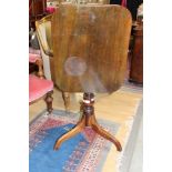 A 19th Century mahogany tilt top tripod table, raised on a turned column,