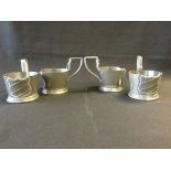 A set of four pewter demi tasse holders,