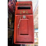 A mid 20th Century Elizabeth II Royal Mail red pole standing post box