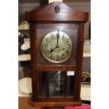 A mahogany wall clock, metal dial, Arabic numerals, pendulum,