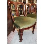 A set of four Victorian walnut dining chairs, circa 1880, carved backs, square back splats,