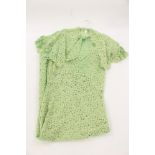 An apple green lace early 1930s lace evening frock with matching cape