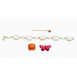 A carnelian and yellow metal brooch; together with a stick pin with garnet and seed pearls,