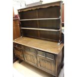 An oak dresser and rack, the rack with two shelves,