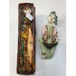 A Balinese wall hanging figurine;