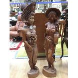 A pair of carved hardwood ladies,