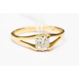 A diamond solitaire ring on 18ct gold, claw set with a old cushion cut diamond,