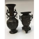 A Japanese Meiji period bronze twin handled vase and another on an incorporated stand (2)