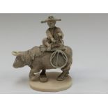 Japanese Meiji period ivory Okinomo, of a farmer seated on a bull, square seal mark to base,