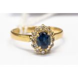 An 18ct sapphire and diamond cluster ring, total diamond weight approx 0.