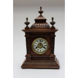 A late 19th Century oak case and mantel clock