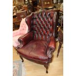 ***TO BE SOLD BY PRIVATE TREATIE*** A 20th Century red leather deep button backed wing chair,