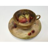 A Royal Worcester fruit painted cup and saucer,