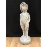 A whistling boy, composite garden ornament,